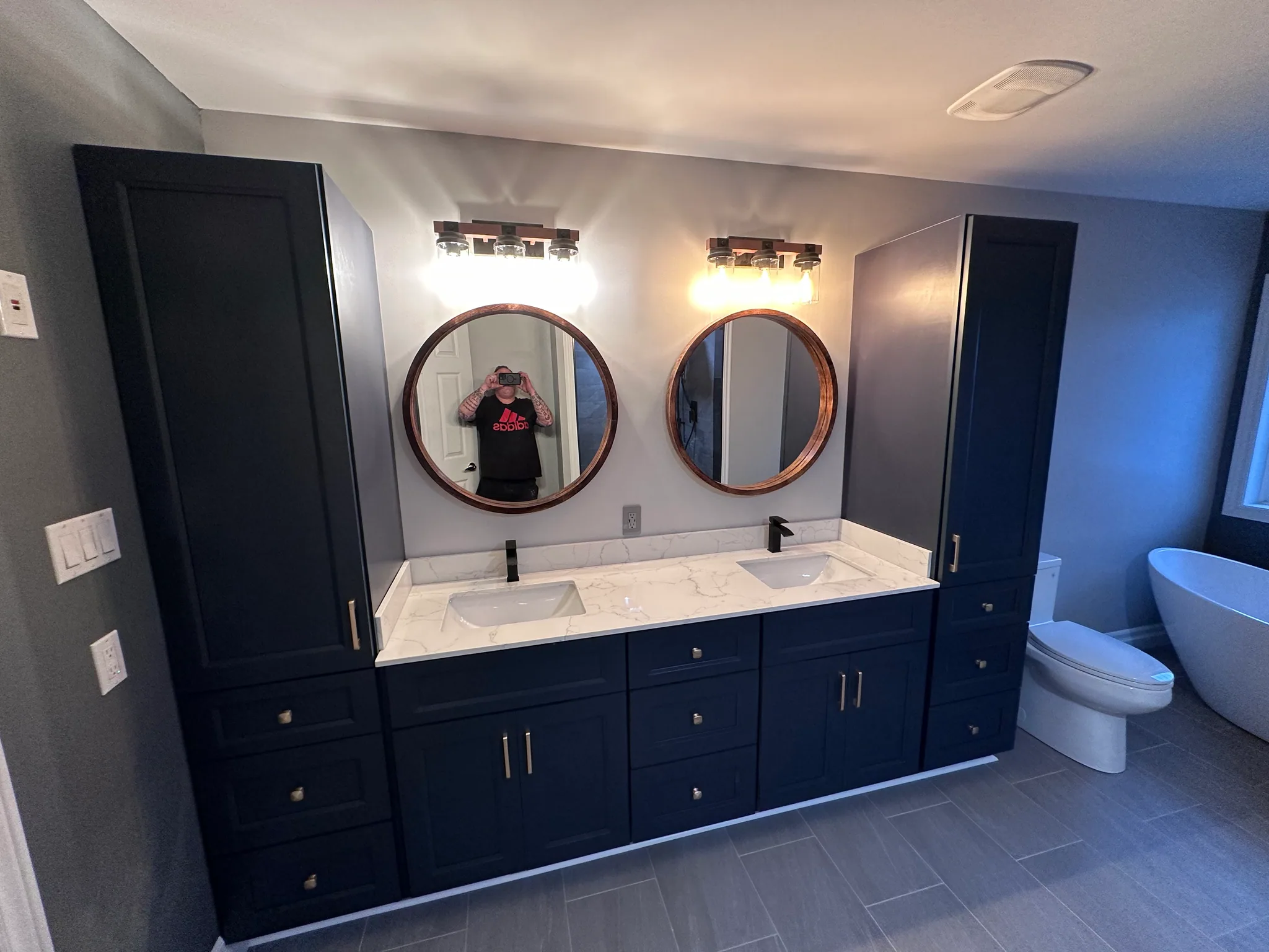 Bathroom with a double vanity and blue cabinets