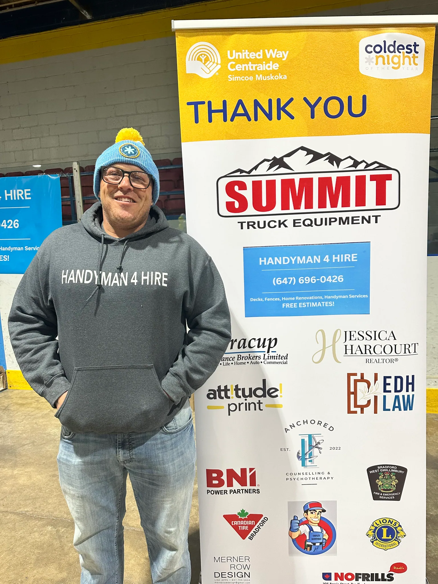 Robert in a Handyman 4 Hire hoodie beside a sponsor thank you banner