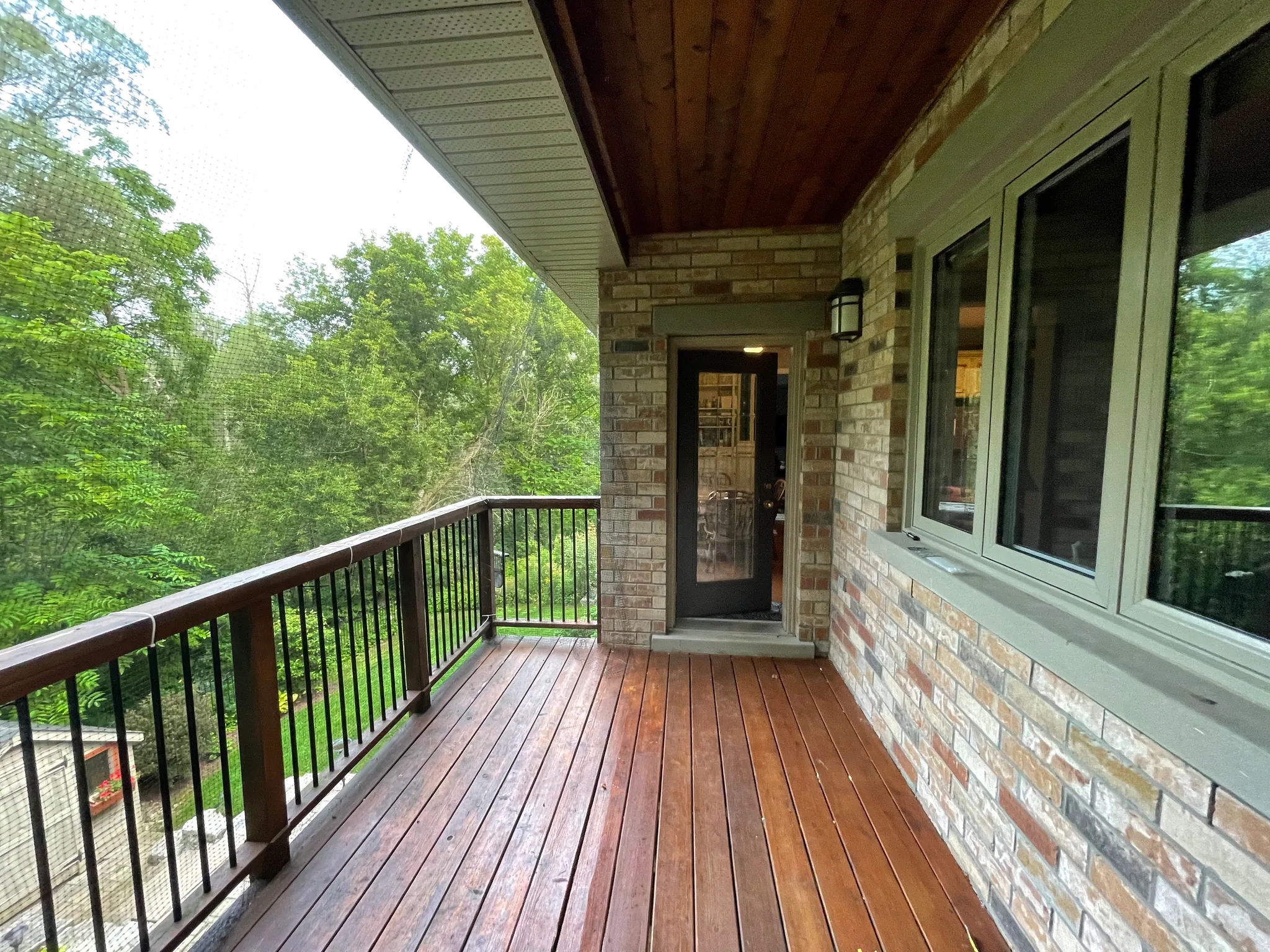 Wood deck boards and railing beside the back door