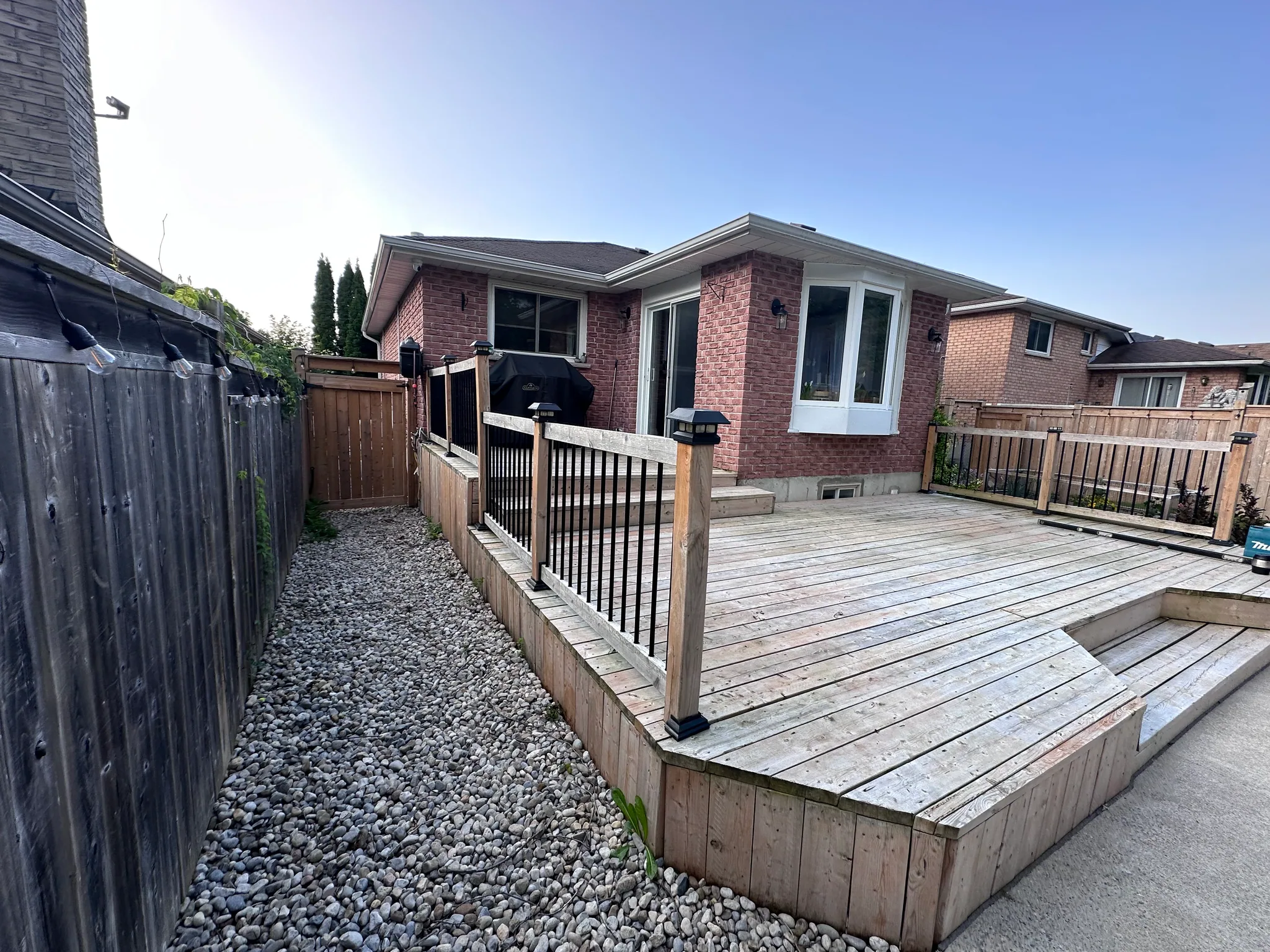 Wood deck with black railing and wide steps