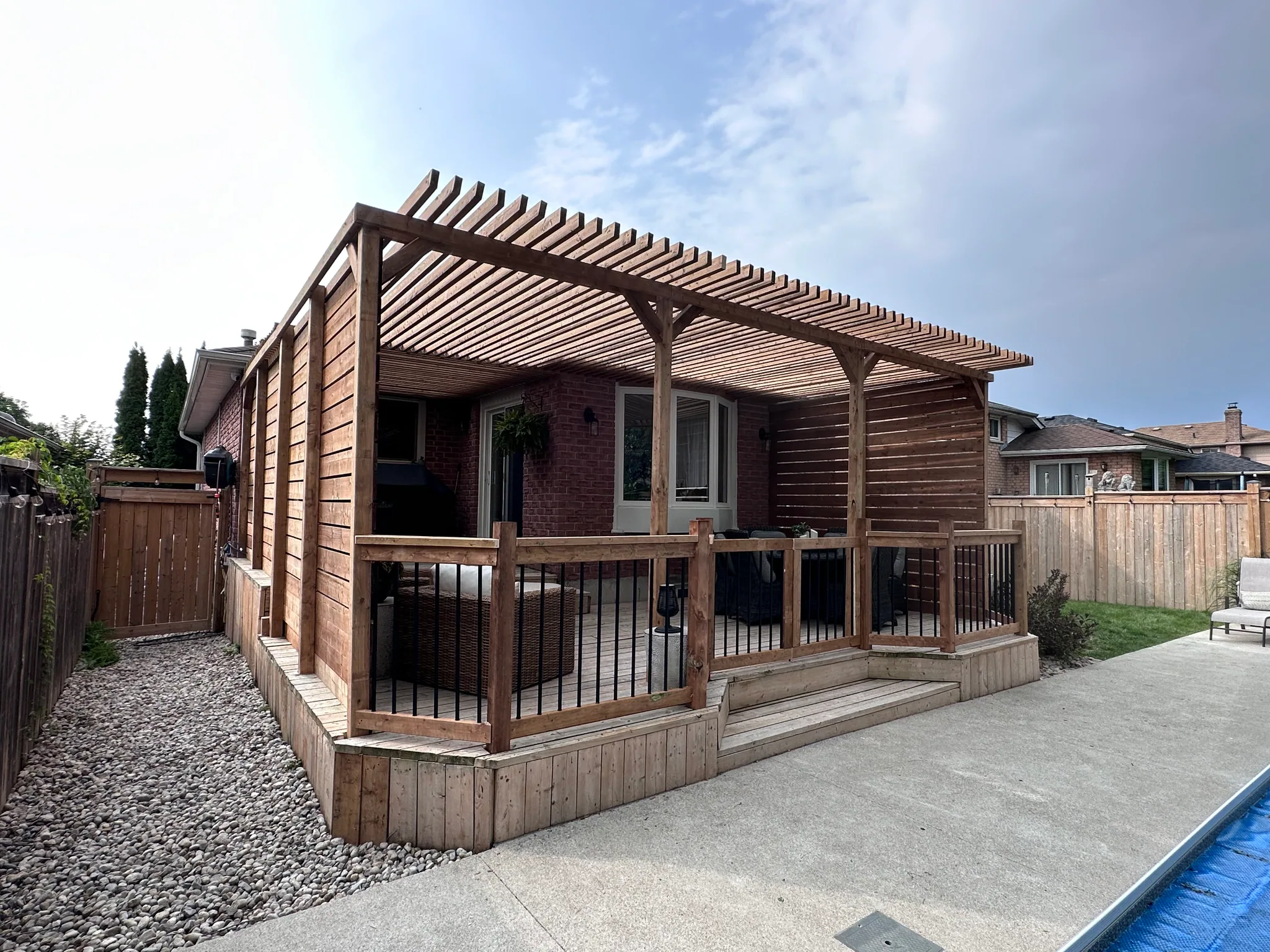 Backyard deck with a wood shade structure