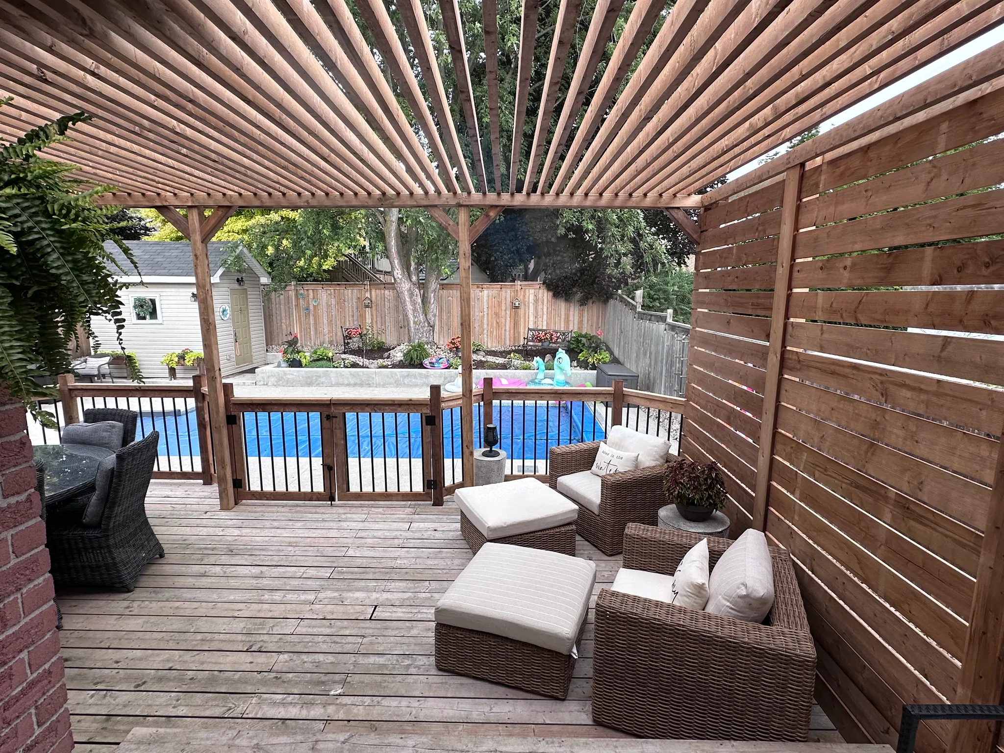 Seating area beneath a slatted wood shade structure