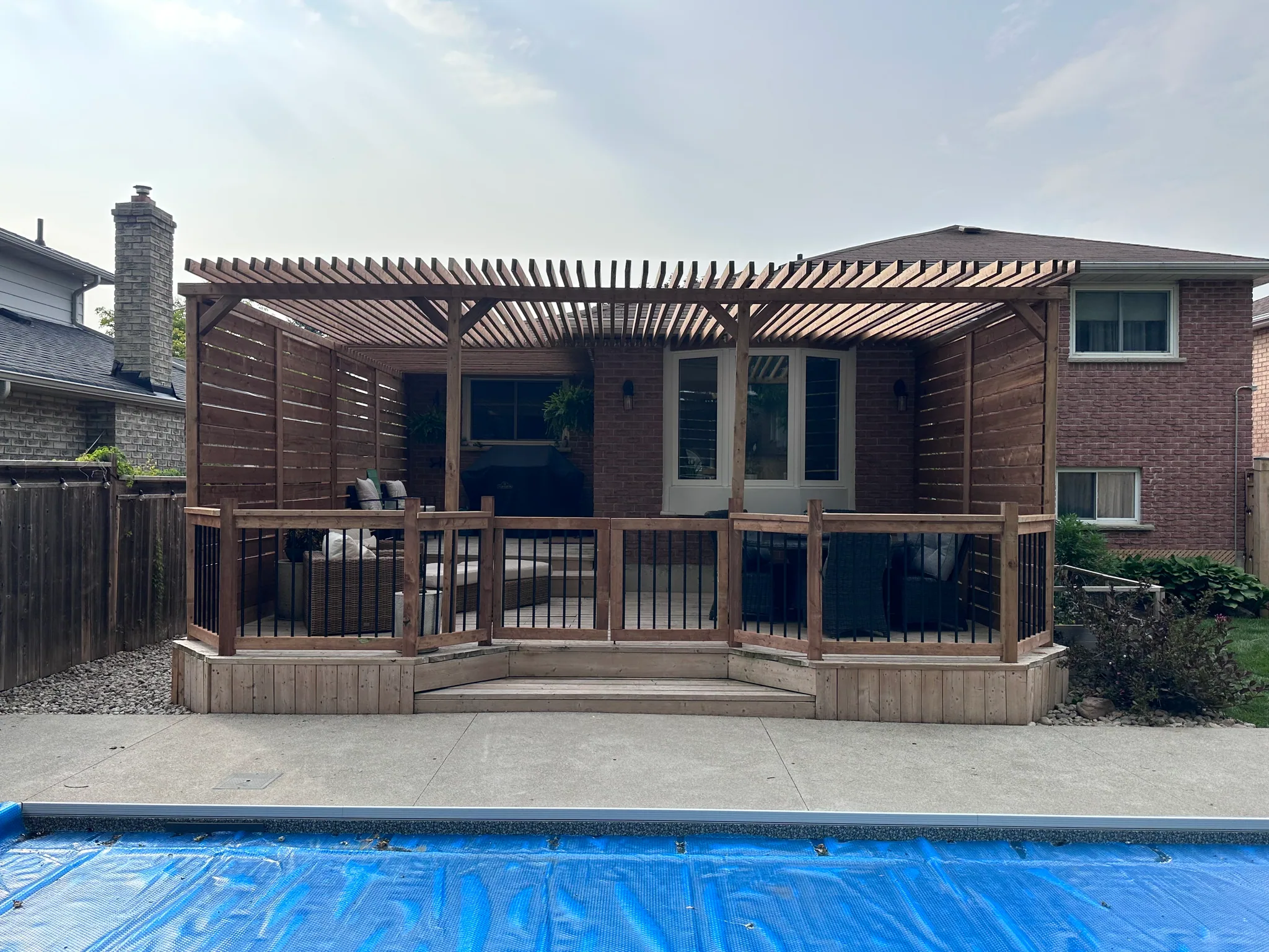 Poolside deck with wood privacy screens
