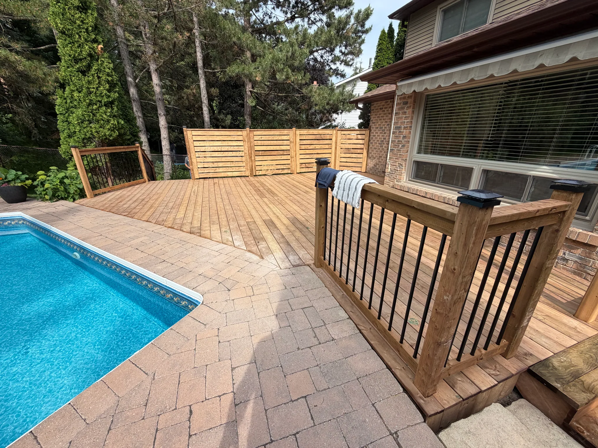 Wood deck beside a swimming pool