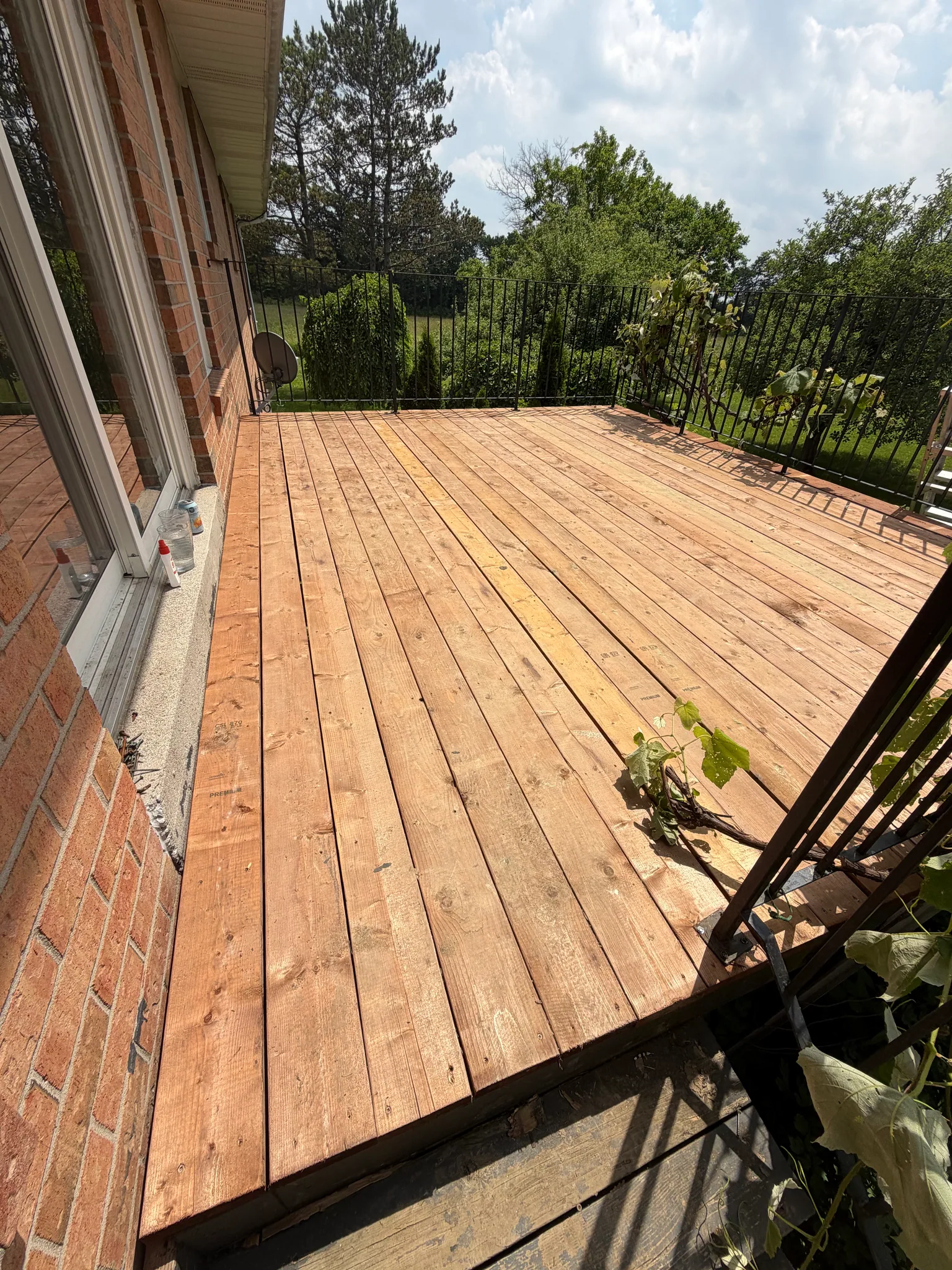 Wood deck with black metal railing