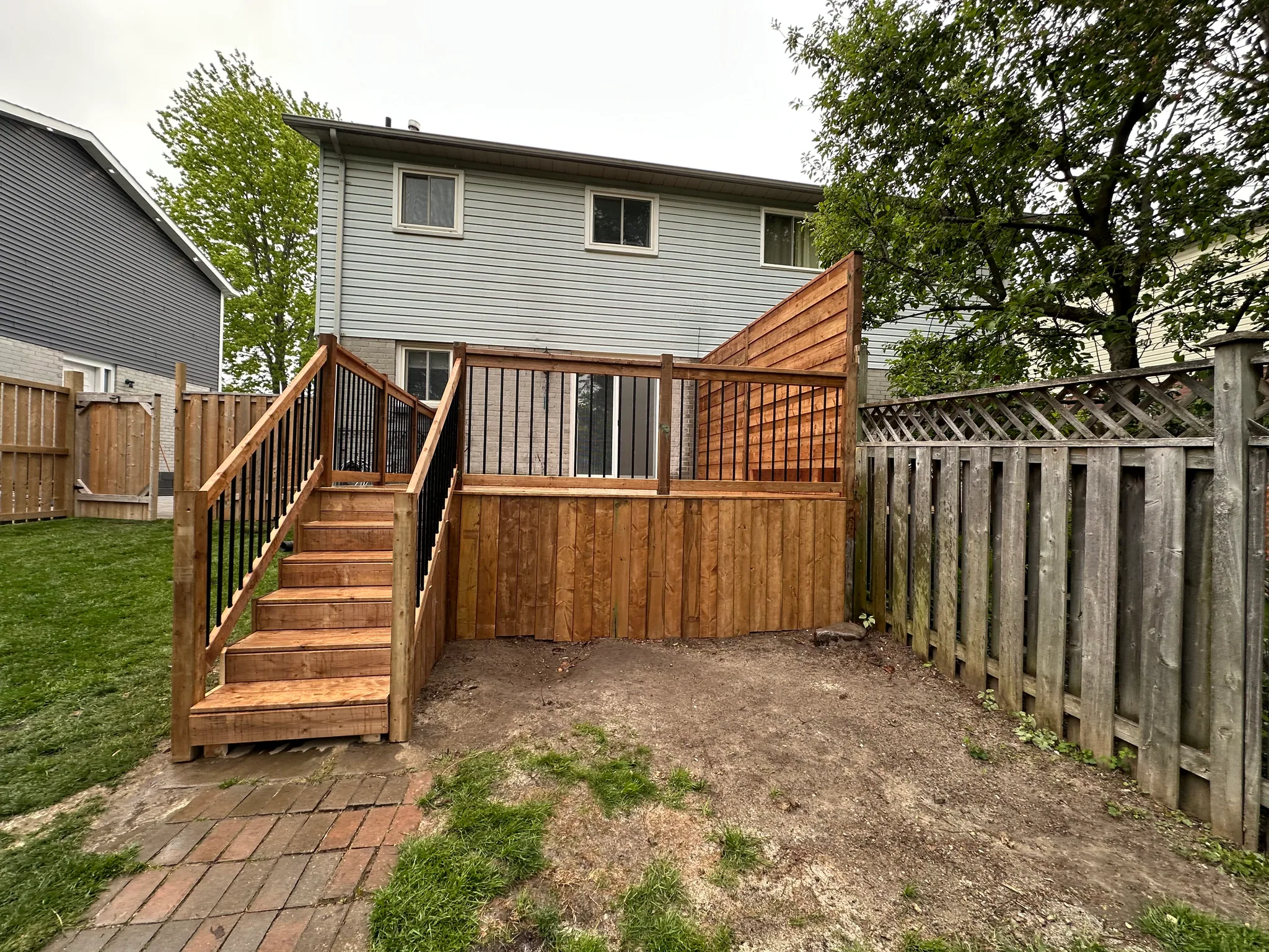 Side view of raised deck stairs and railing