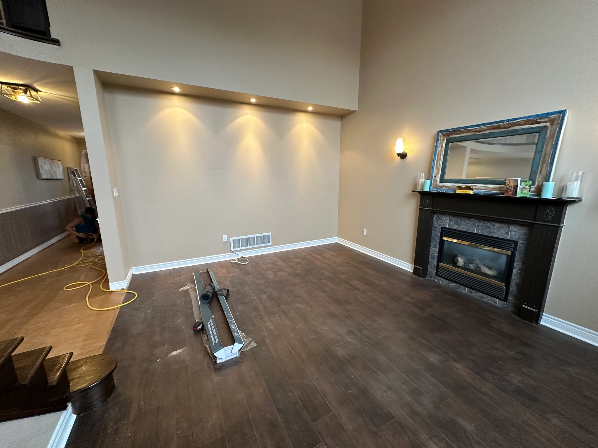 Wood flooring in a living room with a fireplace