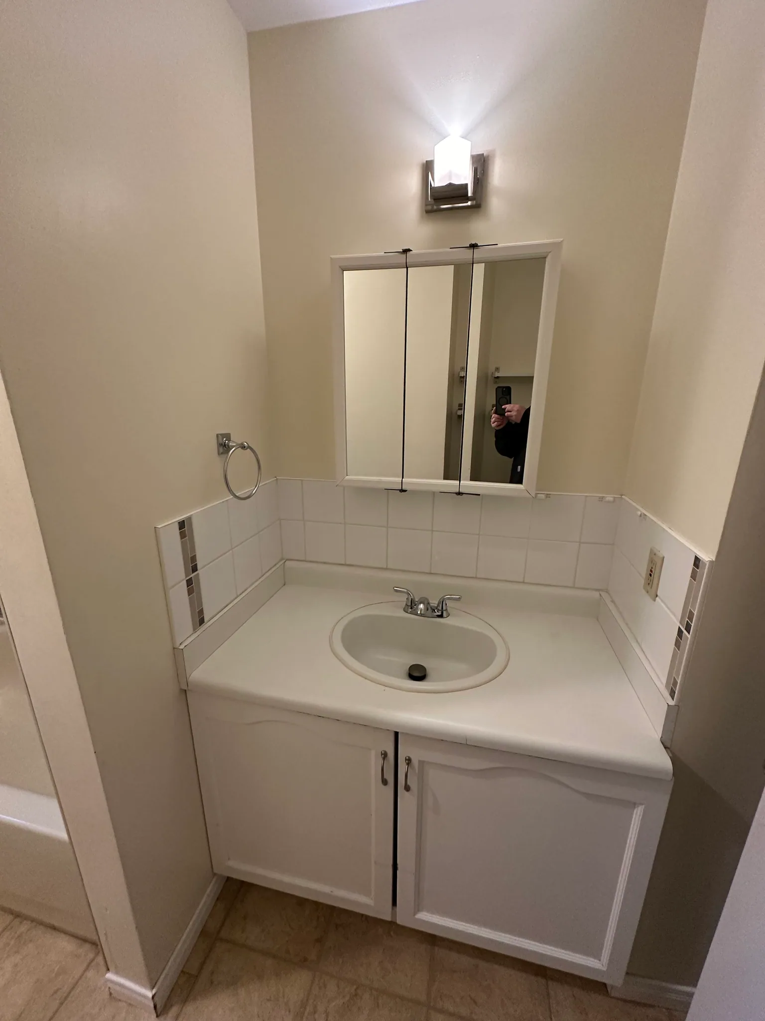 White tile backsplash around a bathroom vanity