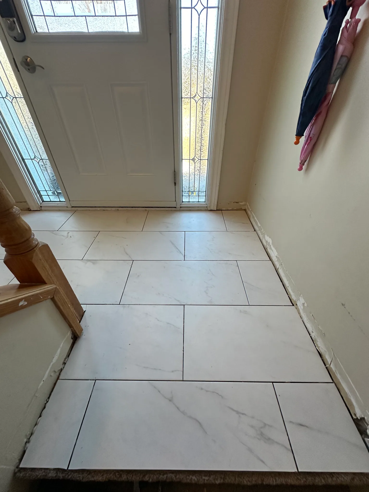 White marble-look floor tiles at a front door