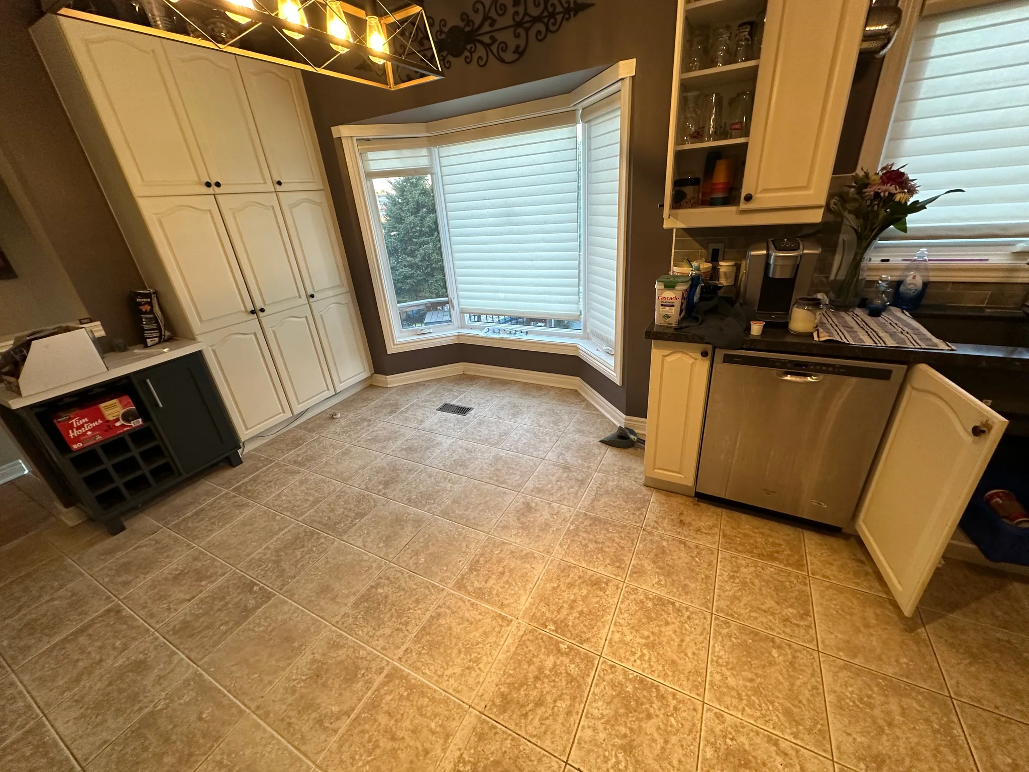 Beige floor tiles beneath a kitchen bay window